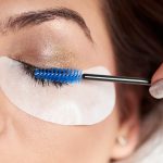 Beautiful woman with long eyelashes in a beauty salon. Eyelash extension procedure.